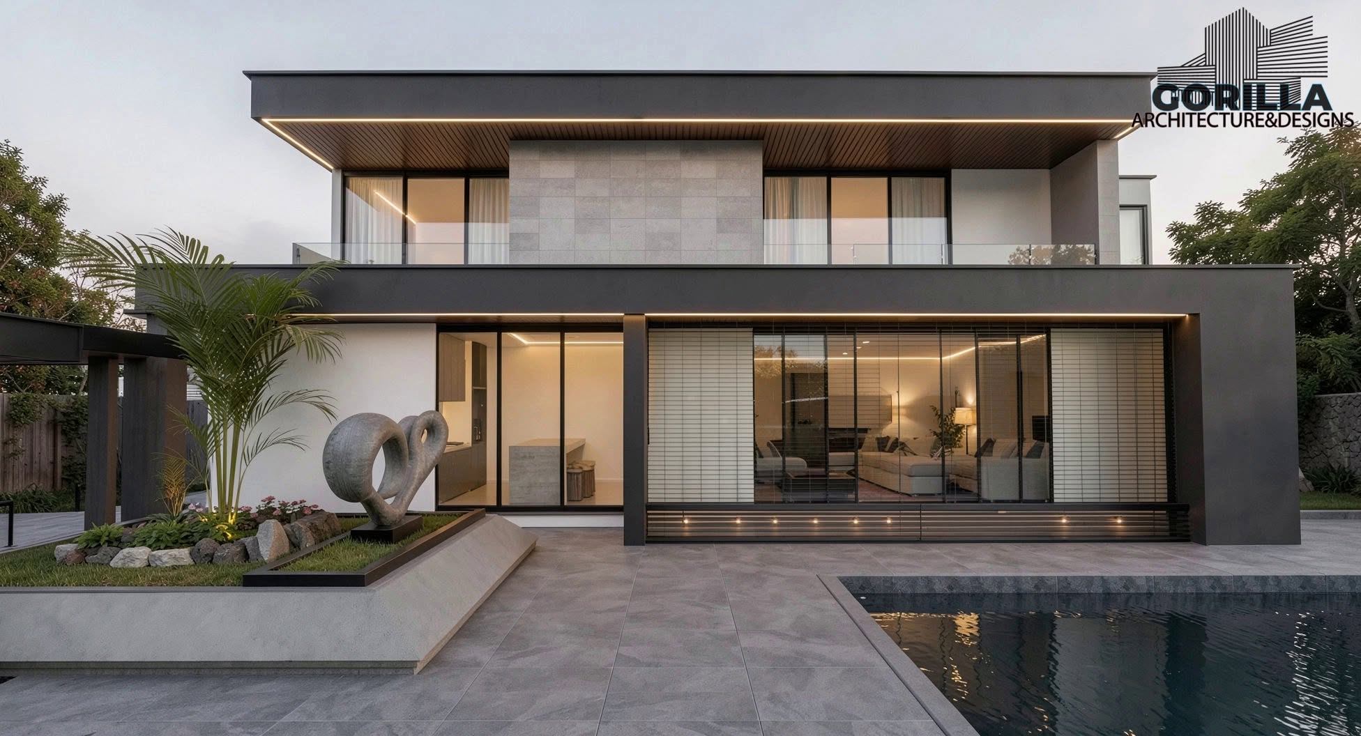A two-storey residence at dusk with a lit timber soffit, full-height glazing and a reflecting pool.